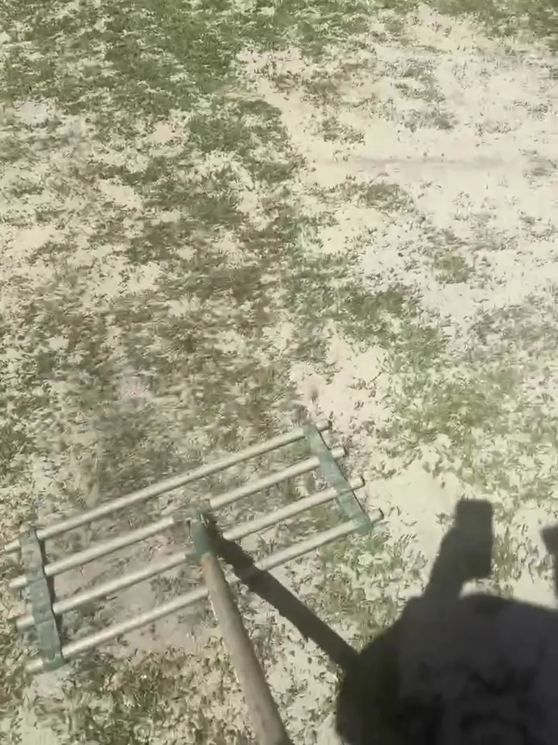 Topsoil spreader spreading sandy topdressing over a scalped Sir Walter Buffalo lawn