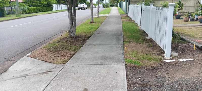 Dying Couch grass on footpath strip along the street with patchy coverage and bare soil